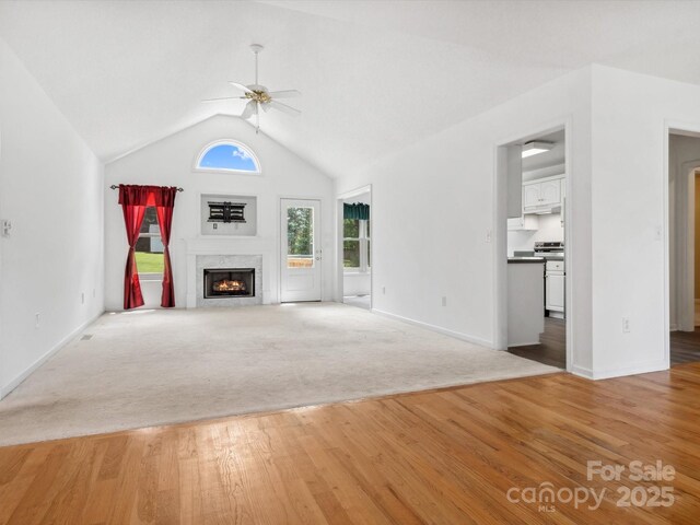 1028 Swaying Oats Dr, York, SC 29745 - unfurnished living room with a ceiling fan, light wood-type flooring, a premium fireplace, vaulted ceiling, and baseboards