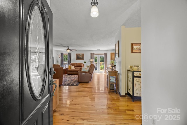 425 Troutman Rd, Rockwell, NC 28138 - entryway featuring light wood finished floors, a textured ceiling, and a ceiling fan