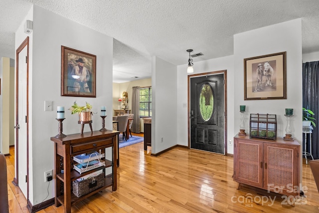 425 Troutman Rd, Rockwell, NC 28138 - entrance foyer featuring light wood finished floors, a textured ceiling, and baseboards