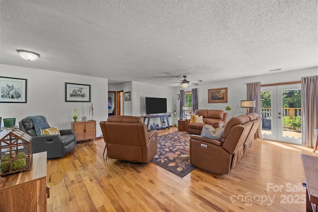 425 Troutman Rd, Rockwell, NC 28138 - living room featuring a textured ceiling, light wood finished floors, french doors, and ceiling fan