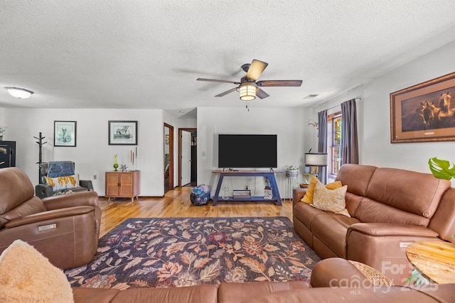 425 Troutman Rd, Rockwell, NC 28138 - living room with a textured ceiling, wood finished floors, and ceiling fan