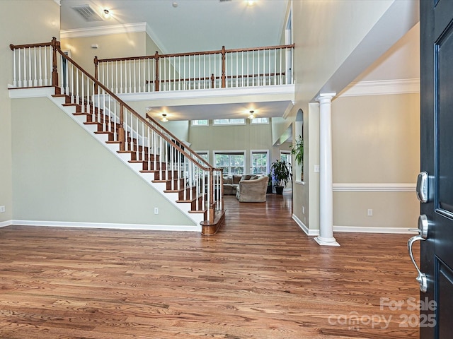 410 Deer Brush Ln, Waxhaw, NC 28173 - foyer entrance featuring ornate columns, wood finished floors, stairs, baseboards, and ornamental molding