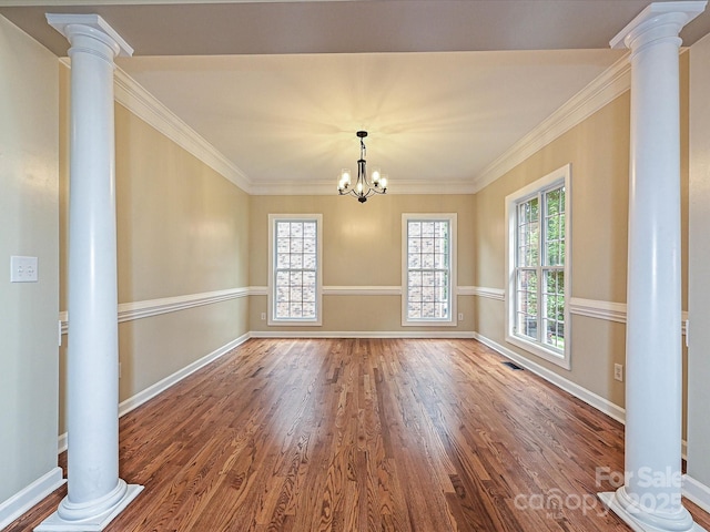 410 Deer Brush Ln, Waxhaw, NC 28173 - unfurnished dining area featuring wood finished floors, baseboards, crown molding, a chandelier, and ornate columns