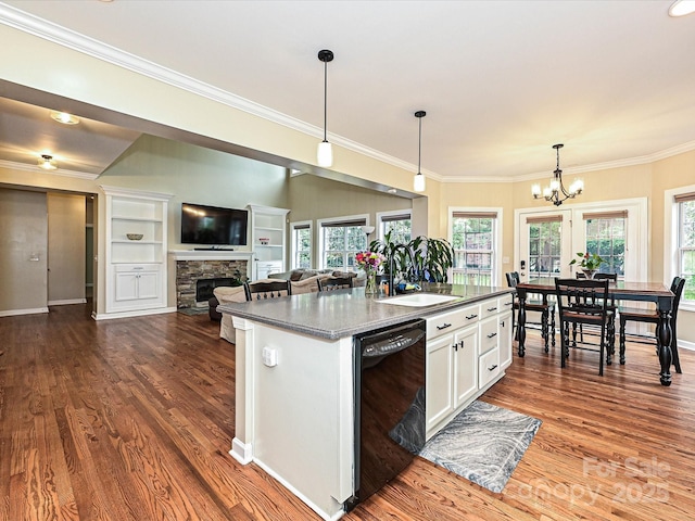 410 Deer Brush Ln, Waxhaw, NC 28173 - kitchen with black dishwasher, dark wood-type flooring, white cabinetry, a fireplace, and a sink