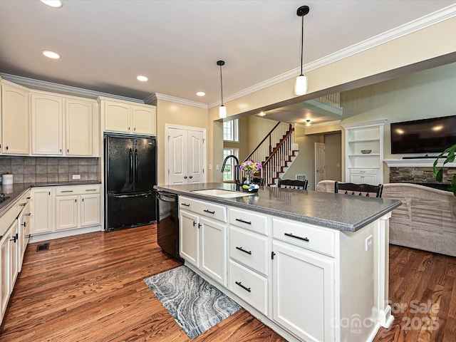 410 Deer Brush Ln, Waxhaw, NC 28173 - kitchen with black appliances, a sink, dark countertops, dark wood-style flooring, and crown molding