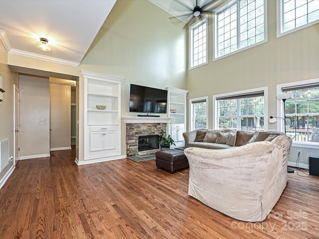 410 Deer Brush Ln, Waxhaw, NC 28173 - living room with baseboards, a ceiling fan, a fireplace, wood finished floors, and a high ceiling