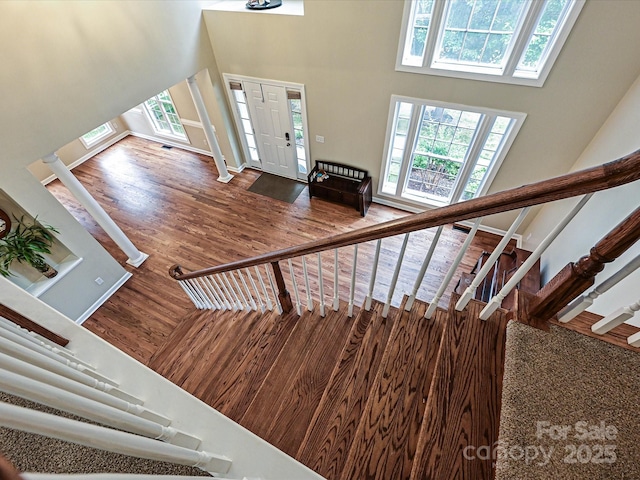 410 Deer Brush Ln, Waxhaw, NC 28173 - stairway with a towering ceiling, wood finished floors, and decorative columns