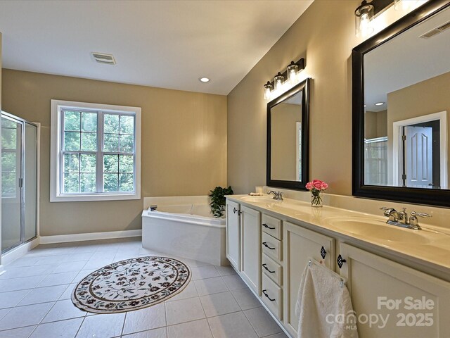 410 Deer Brush Ln, Waxhaw, NC 28173 - bathroom with tile patterned floors, a stall shower, a garden tub, double vanity, and baseboards