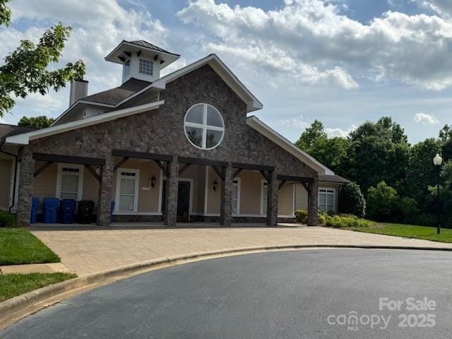 410 Deer Brush Ln, Waxhaw, NC 28173 - view of front facade featuring stone siding and a chimney