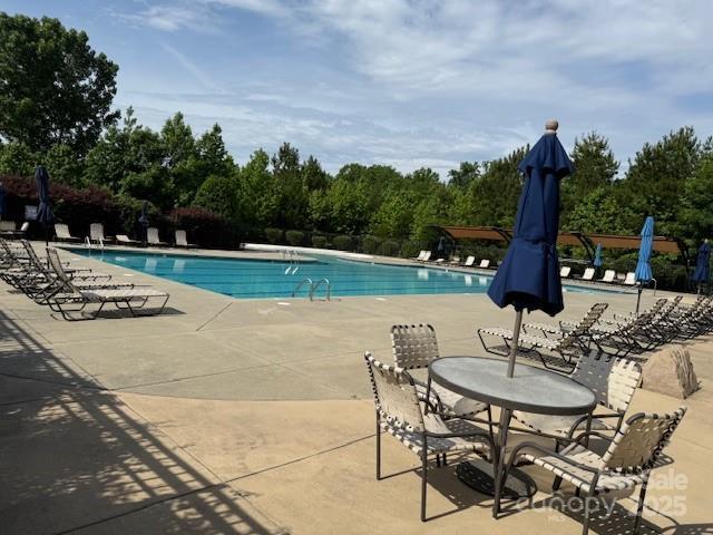 410 Deer Brush Ln, Waxhaw, NC 28173 - community pool featuring a patio area