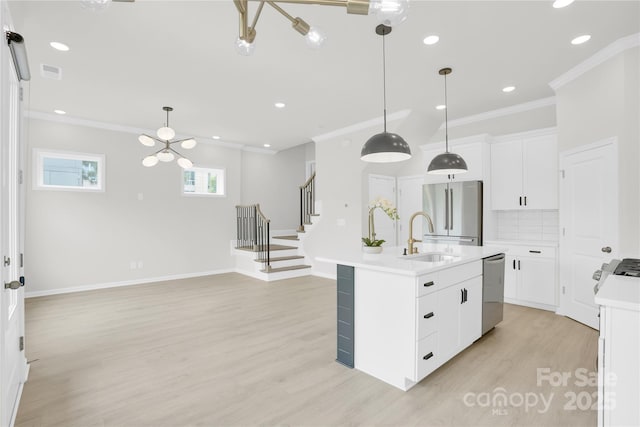5946 Ardrey Kell Rd, Charlotte, NC 28277 - kitchen featuring stainless steel appliances, a sink, light wood finished floors, ornamental molding, and light countertops