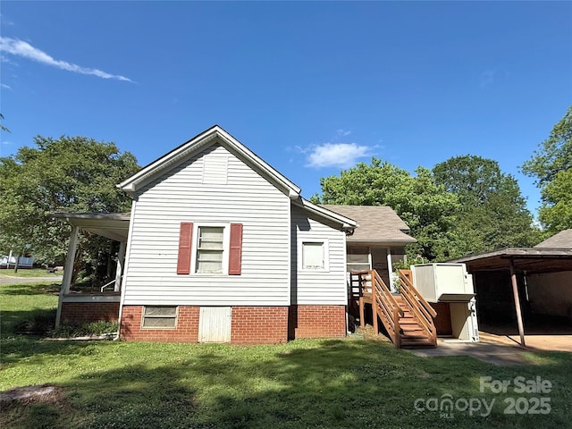 rear view of house with a yard and stairs