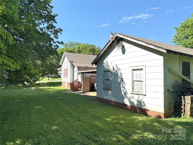 view of side of property with a yard