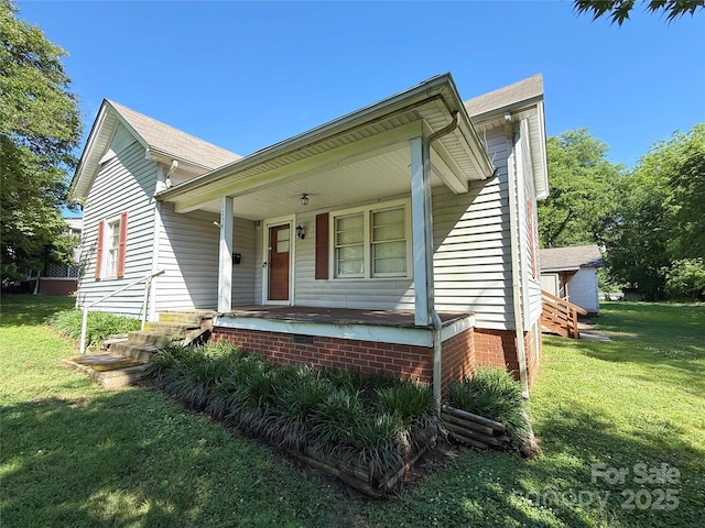 bungalow featuring a front lawn and a porch
