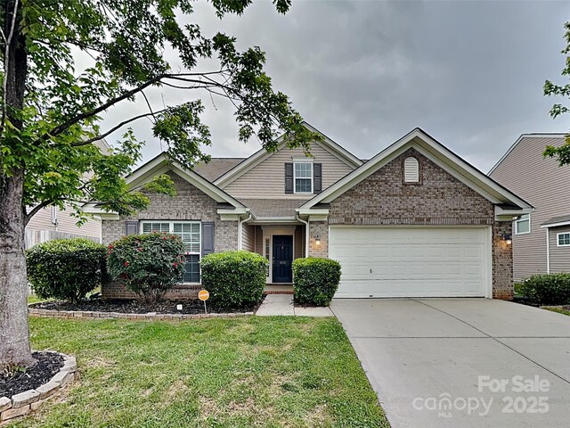 4006 Lawrence Daniel Dr, Matthews, NC 28104 - view of front of property with brick siding, concrete driveway, a front yard, and an attached garage