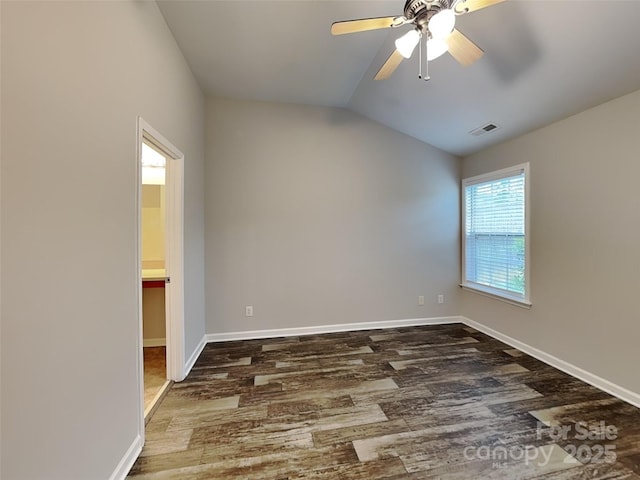 empty room with wood finished floors, ceiling fan, baseboards, and lofted ceiling