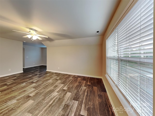unfurnished room featuring wood finished floors, a ceiling fan, and baseboards