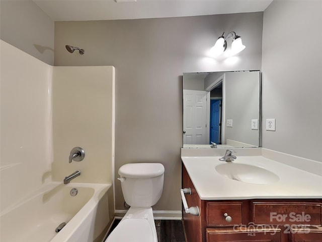 full bathroom with toilet, vanity, shower / tub combination, baseboards, and wood finished floors