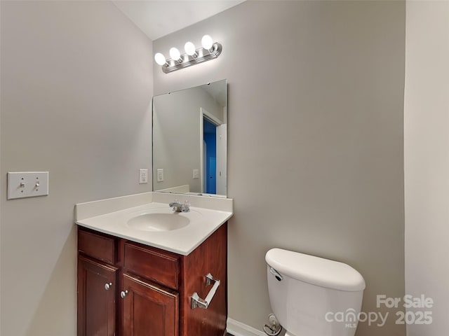half bathroom with toilet and vanity