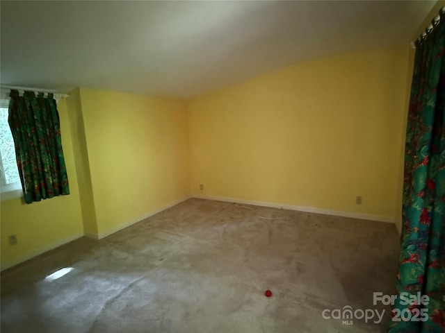 carpeted spare room with baseboards