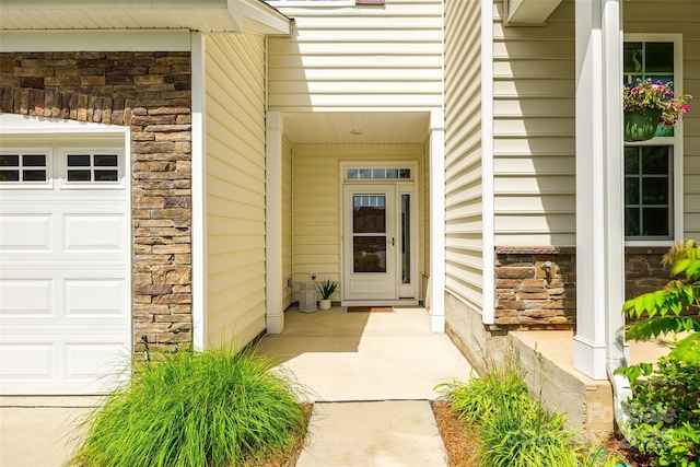 809 River Park Rd, Belmont, NC 28012 - view of exterior entry featuring stone siding, a porch, and a garage