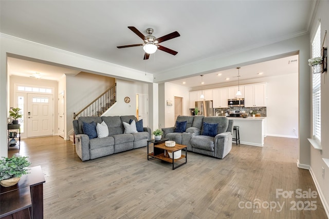 809 River Park Rd, Belmont, NC 28012 - living room with light wood-style flooring, ceiling fan, crown molding, stairs, and baseboards