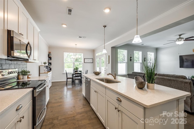 809 River Park Rd, Belmont, NC 28012 - kitchen with stainless steel appliances, a sink, dark wood-type flooring, crown molding, and white cabinetry