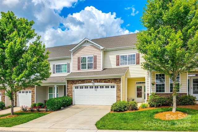 809 River Park Rd, Belmont, NC 28012 - townhome / multi-family property featuring a garage, concrete driveway, a shingled roof, and stone siding