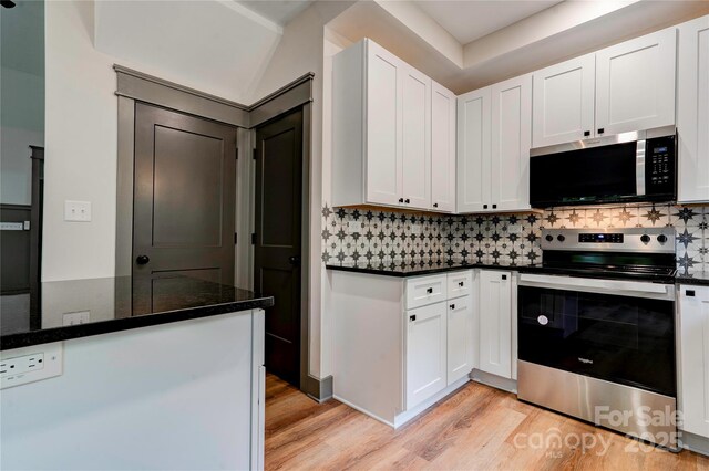 600 S Cline Ave, Newton, NC 28658 - kitchen with stainless steel appliances, light wood-style flooring, and white cabinetry
