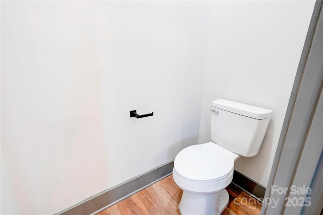 600 S Cline Ave, Newton, NC 28658 - bathroom featuring wood finished floors, toilet, and baseboards