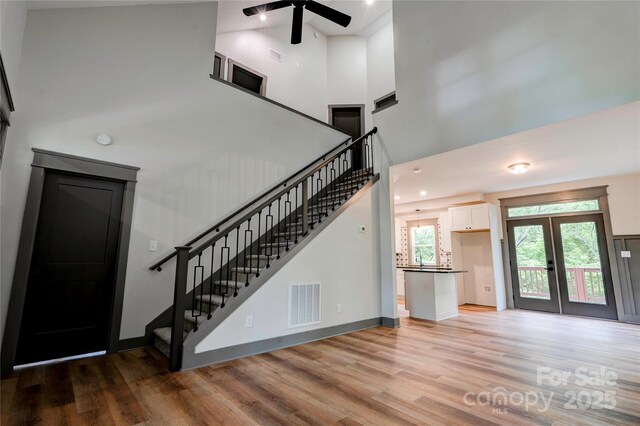 600 S Cline Ave, Newton, NC 28658 - stairs featuring a towering ceiling, wood finished floors, ceiling fan, french doors, and baseboards