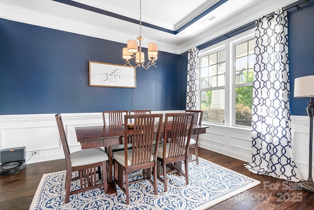 10911 Skymont Dr, Huntersville, NC 28078 - dining area featuring hardwood / wood-style floors, a chandelier, a decorative wall, crown molding, and wainscoting