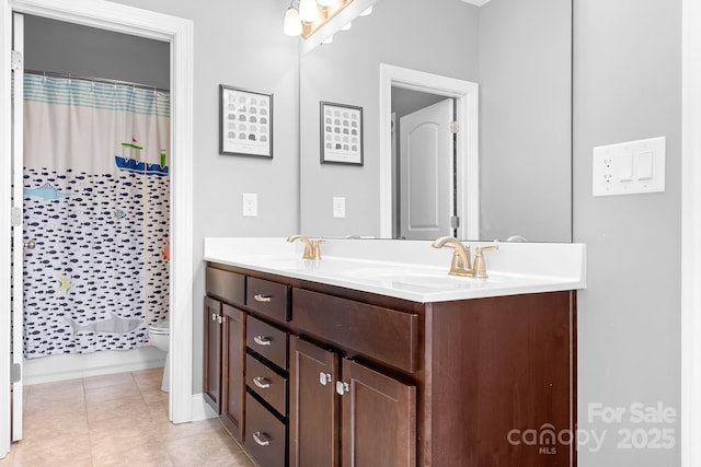10911 Skymont Dr, Huntersville, NC 28078 - full bath with toilet, double vanity, tile patterned flooring, and baseboards