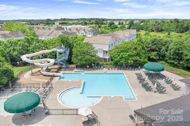 10911 Skymont Dr, Huntersville, NC 28078 - community pool featuring a water slide, a patio area, and view of wooded area