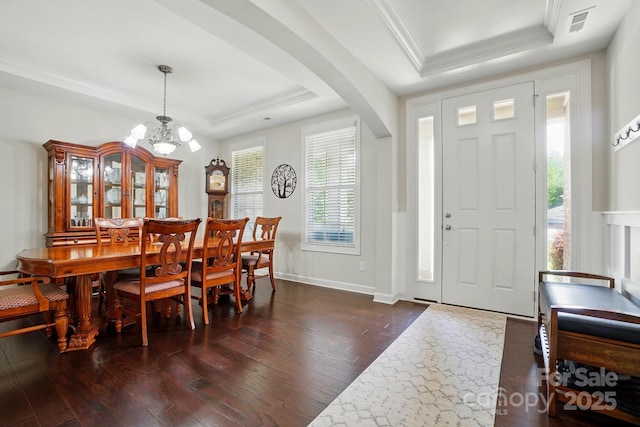 161 Leaning Tower Dr, Mooresville, NC 28117 - foyer entrance with a raised ceiling, arched walkways, ornamental molding, dark wood-style flooring, and a chandelier