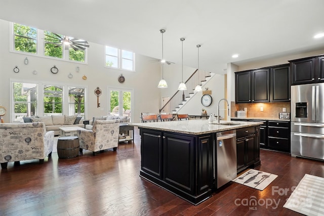 161 Leaning Tower Dr, Mooresville, NC 28117 - kitchen with stainless steel appliances, a sink, dark cabinetry, open floor plan, and recessed lighting