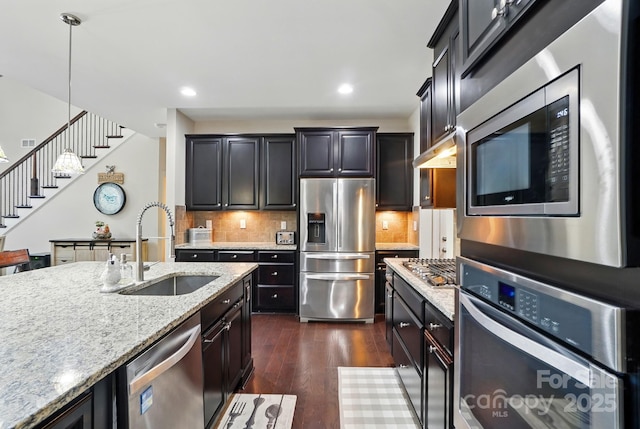 161 Leaning Tower Dr, Mooresville, NC 28117 - kitchen with appliances with stainless steel finishes, a sink, dark wood-style flooring, pendant lighting, and light stone counters