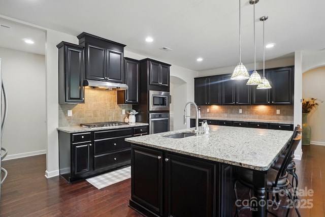 161 Leaning Tower Dr, Mooresville, NC 28117 - kitchen featuring stainless steel appliances, a sink, arched walkways, under cabinet range hood, and recessed lighting