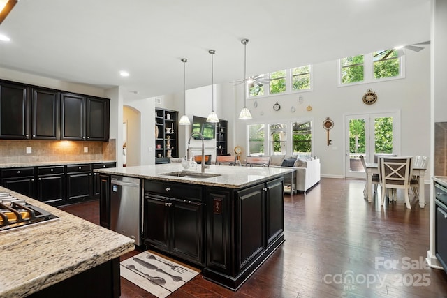 161 Leaning Tower Dr, Mooresville, NC 28117 - kitchen featuring a ceiling fan, appliances with stainless steel finishes, dark cabinets, arched walkways, and a high ceiling