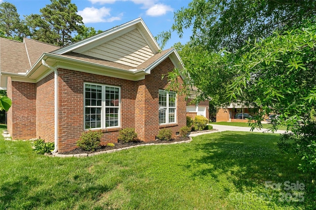 view of side of home featuring brick siding, a yard, and roof with shingles