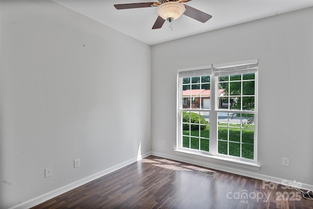 unfurnished room with wood finished floors, baseboards, and a ceiling fan