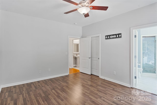 unfurnished room with wood finished floors, a ceiling fan, and baseboards