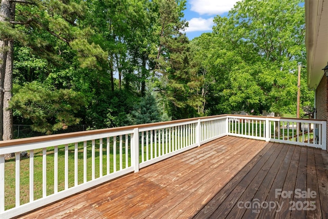 wooden terrace with a lawn