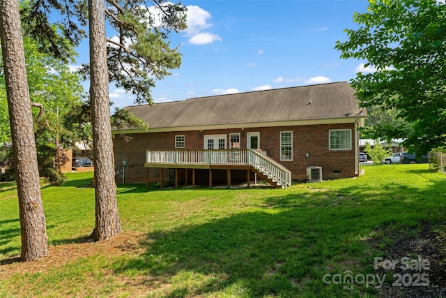 back of house featuring stairs, a deck, a yard, brick siding, and central air condition unit