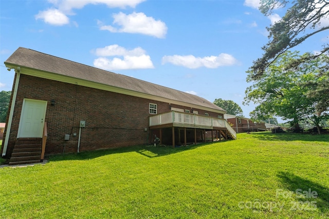 rear view of property with a wooden deck, a lawn, stairs, and entry steps