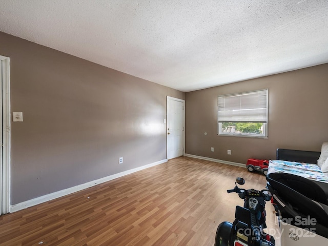 7977 Shady Oak Trl, Charlotte, NC 28210 - bedroom with a textured ceiling, wood finished floors, and baseboards
