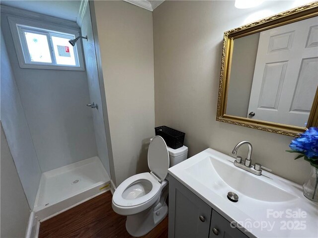 168 Grove St, Mocksville, NC 27028 - bathroom with a shower stall, toilet, vanity, wood finished floors, and crown molding