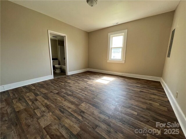 168 Grove St, Mocksville, NC 27028 - unfurnished bedroom featuring dark wood finished floors, baseboards, and connected bathroom