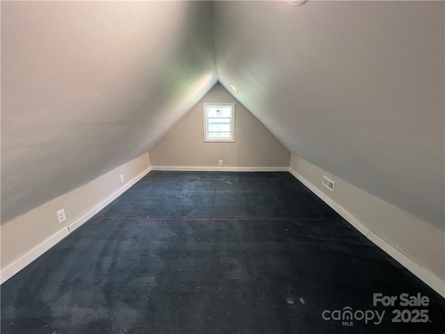 168 Grove St, Mocksville, NC 27028 - bonus room featuring vaulted ceiling, baseboards, and dark colored carpet