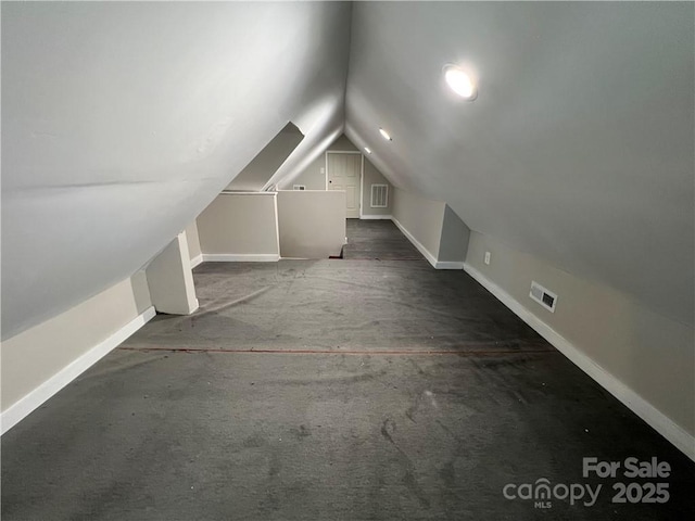 168 Grove St, Mocksville, NC 27028 - bonus room with baseboards, lofted ceiling, and carpet flooring